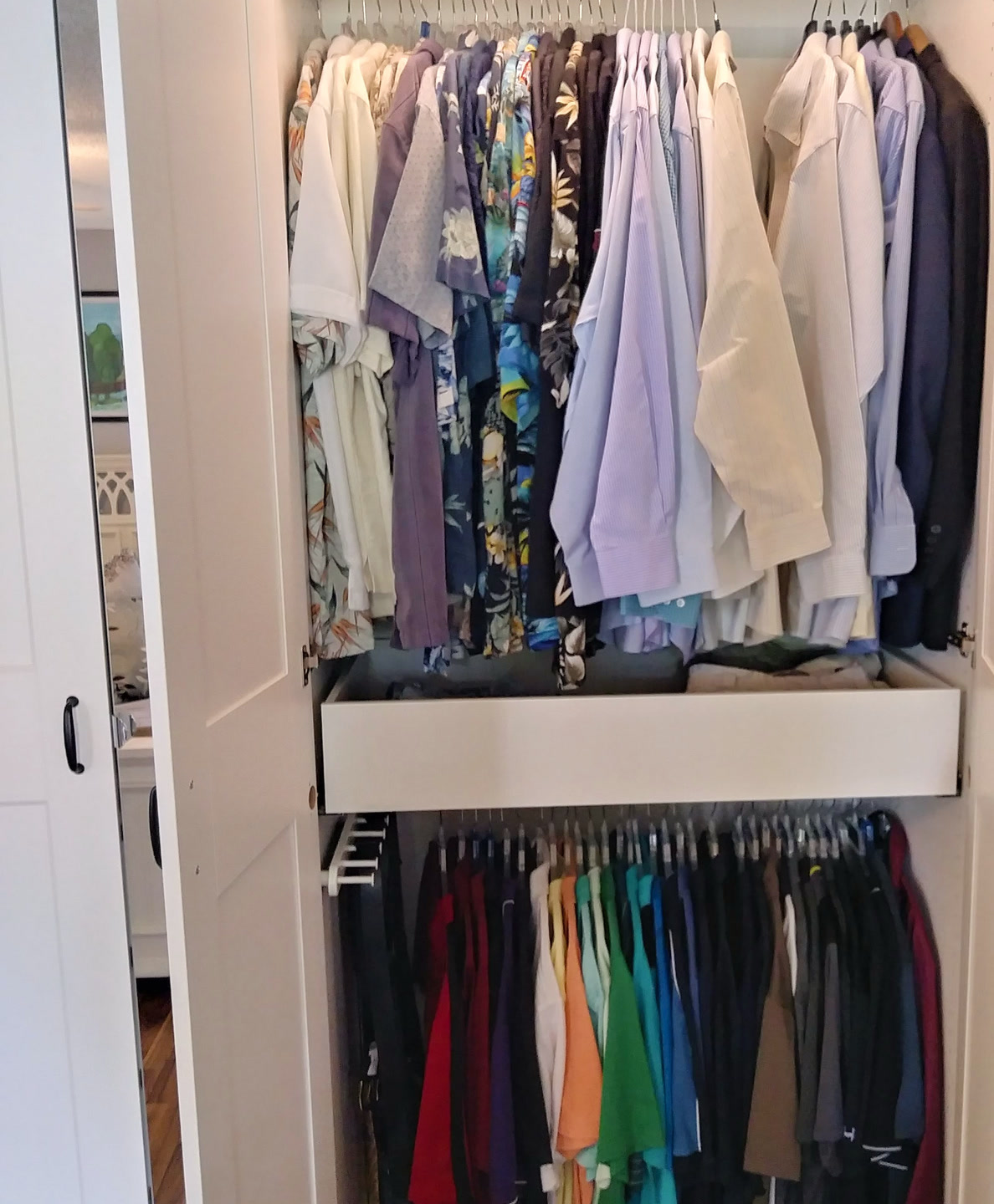 Custom closet section with hanging shirts and lower hanging storage