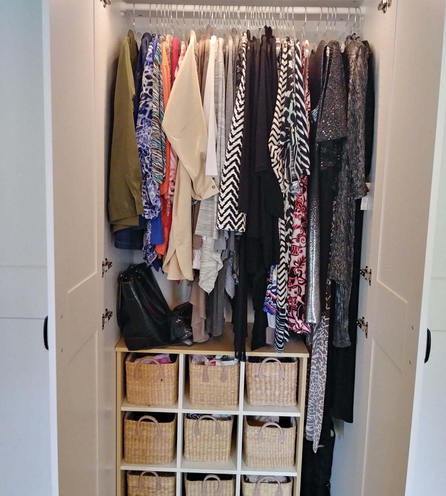 Custom closet with organized hanging clothes and storage shelves
