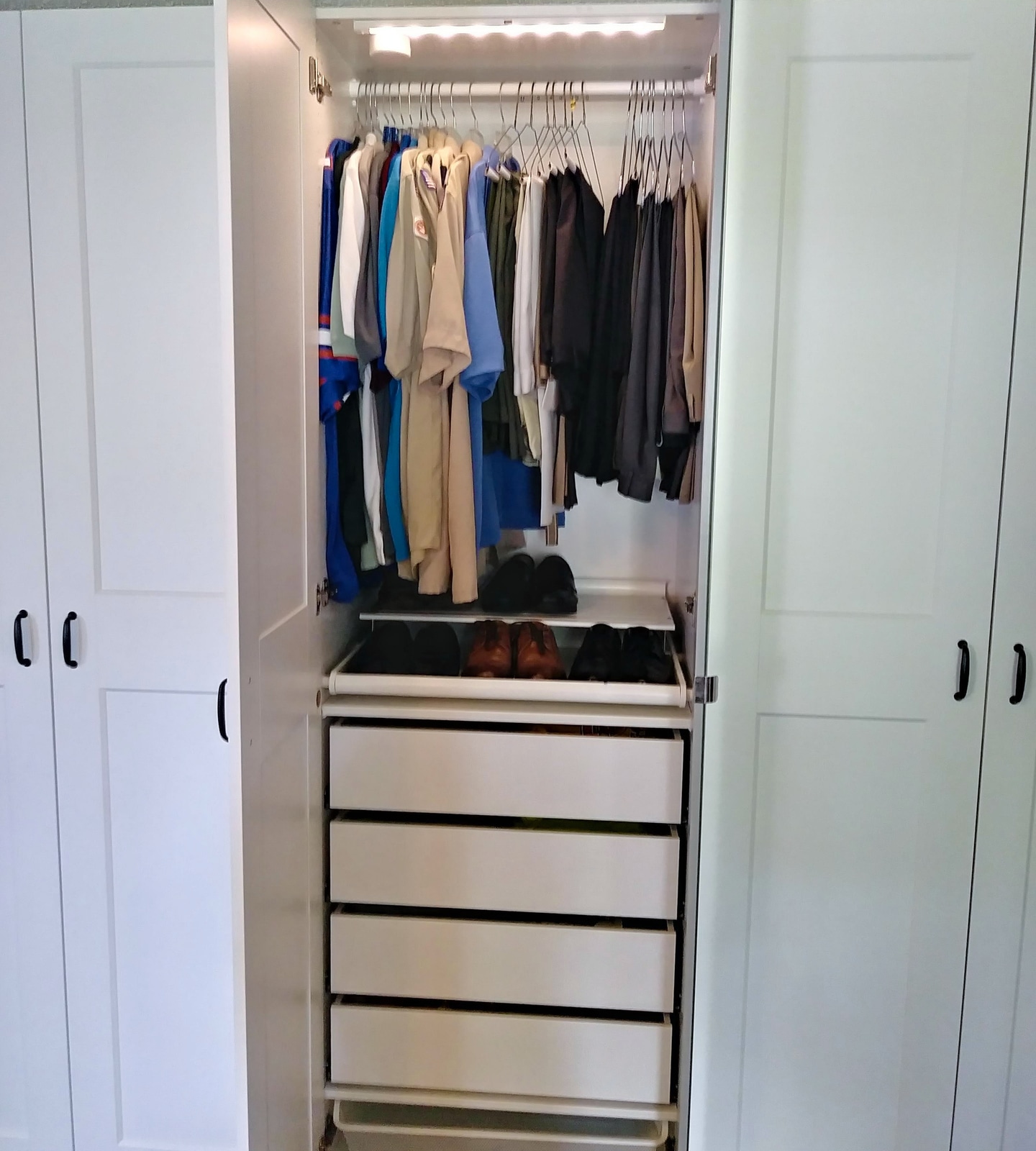 Custom closet showing clothing rods, shelves, and organized sections
