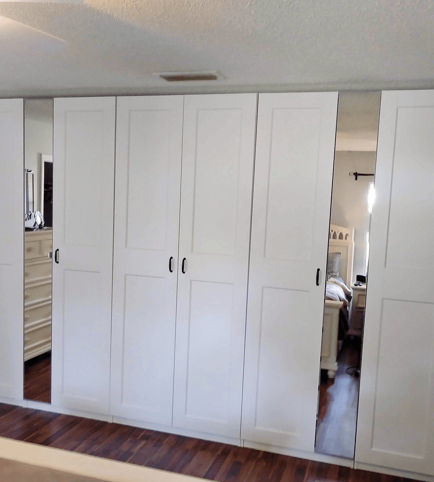 Custom closet with folded clothes, shoe storage, and hanging area