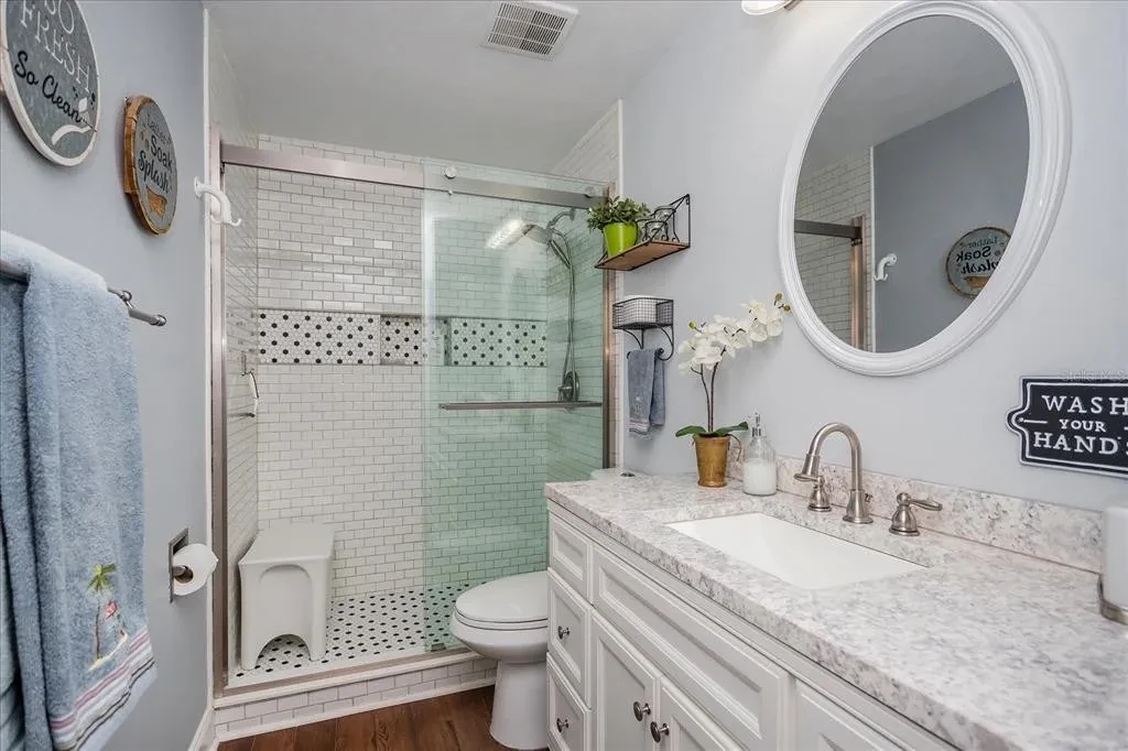 Guest bathroom with clean white vanity and refreshed finishes