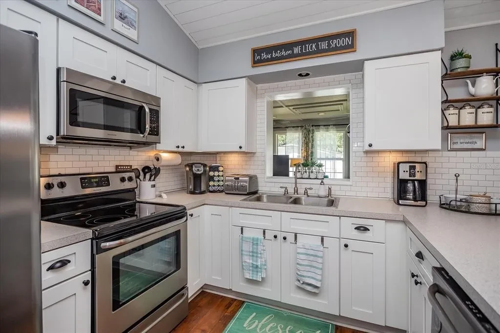 Kitchen with white cabinetry and tidy counters