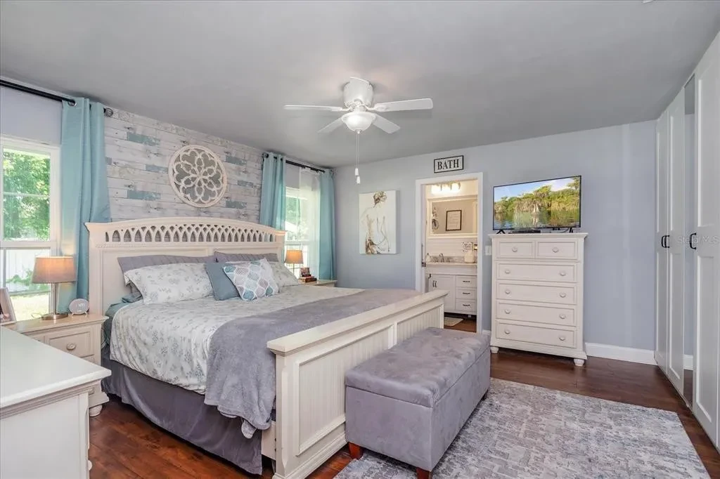 Primary bedroom with calm bedding and styled details