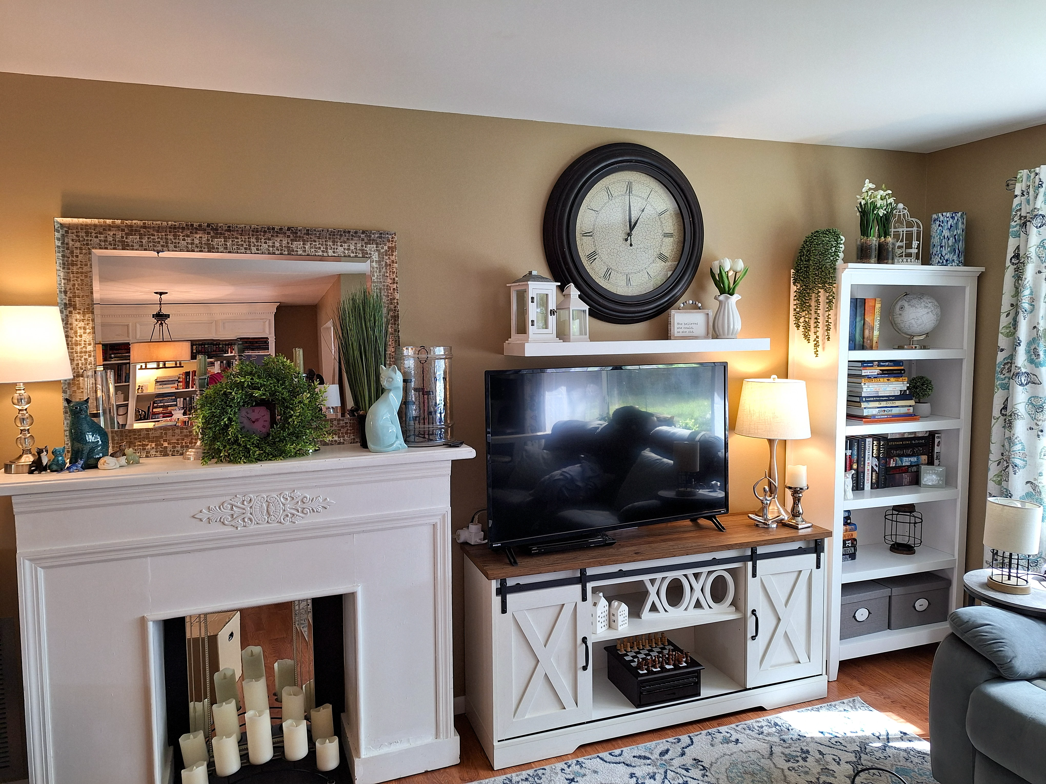 Second angle of living room with fireplace and seating