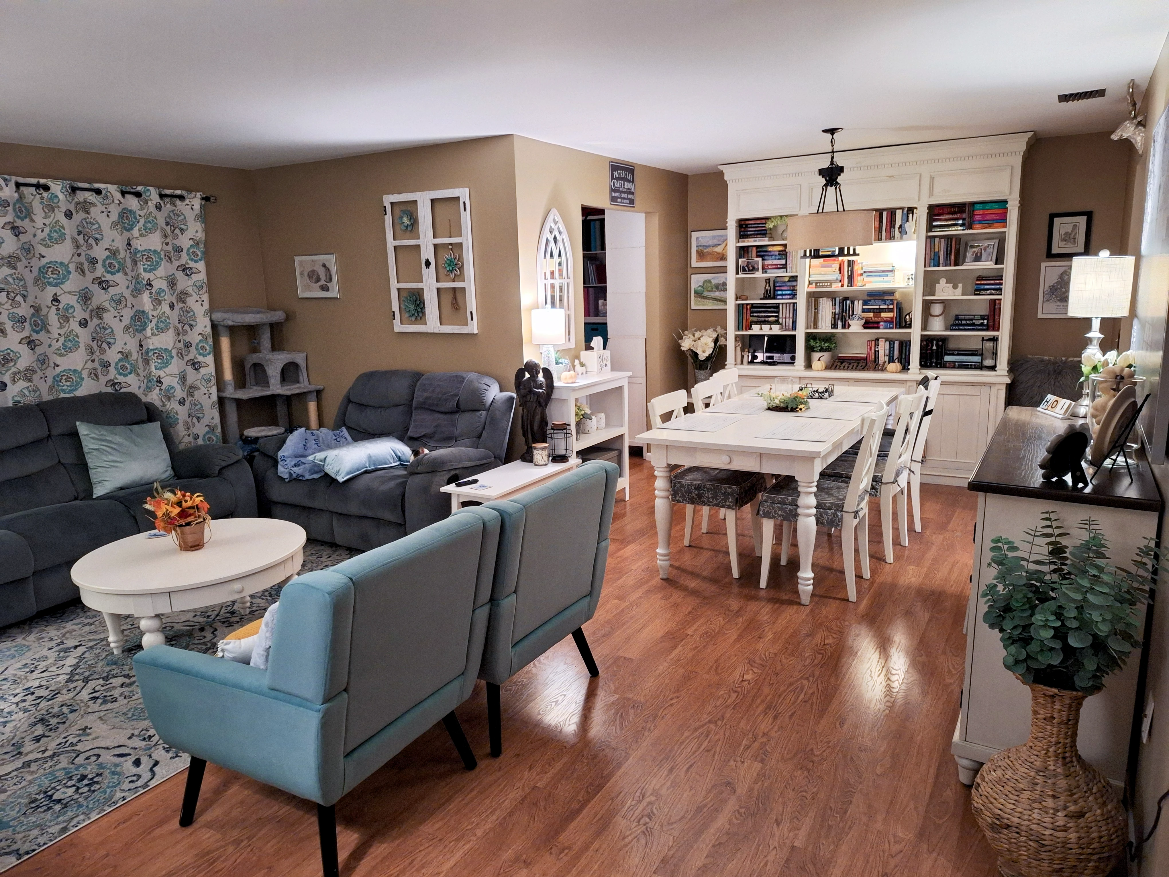 Living room with a white fireplace, leather seating, and layered decor