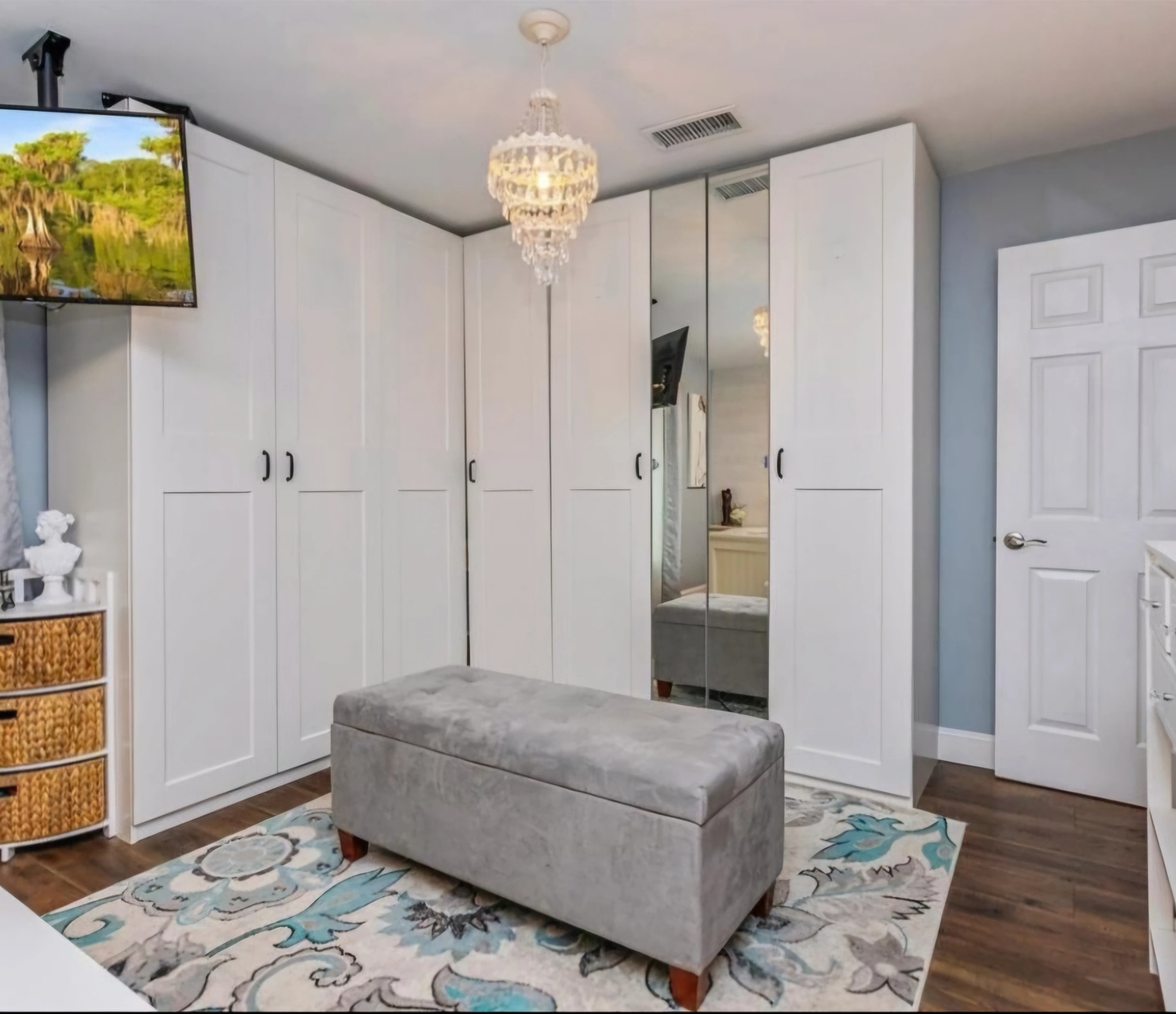 Closet after storage refresh with white shelving and organized hanging space