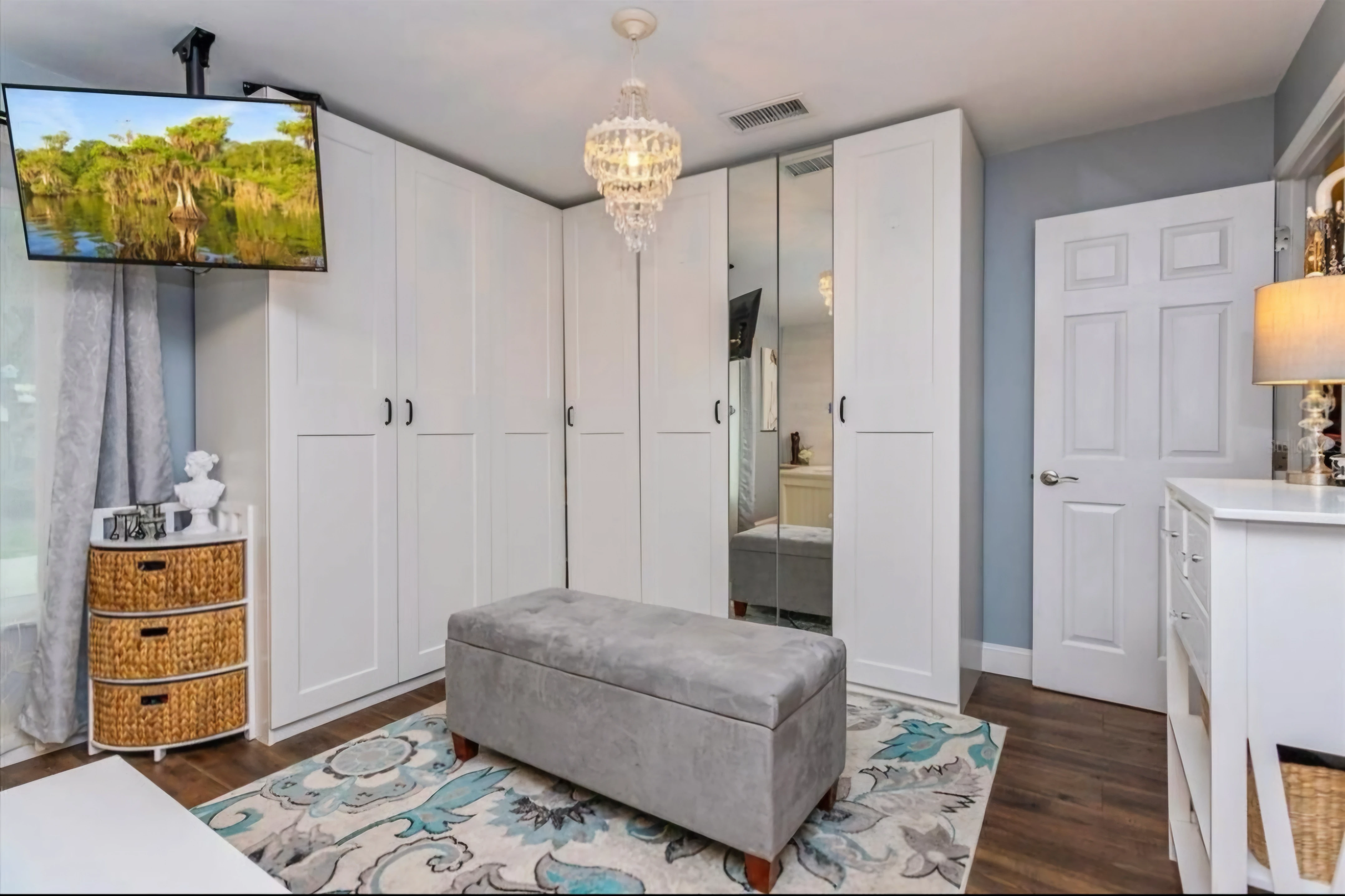 Organized closet storage with white shelving and hanging rods