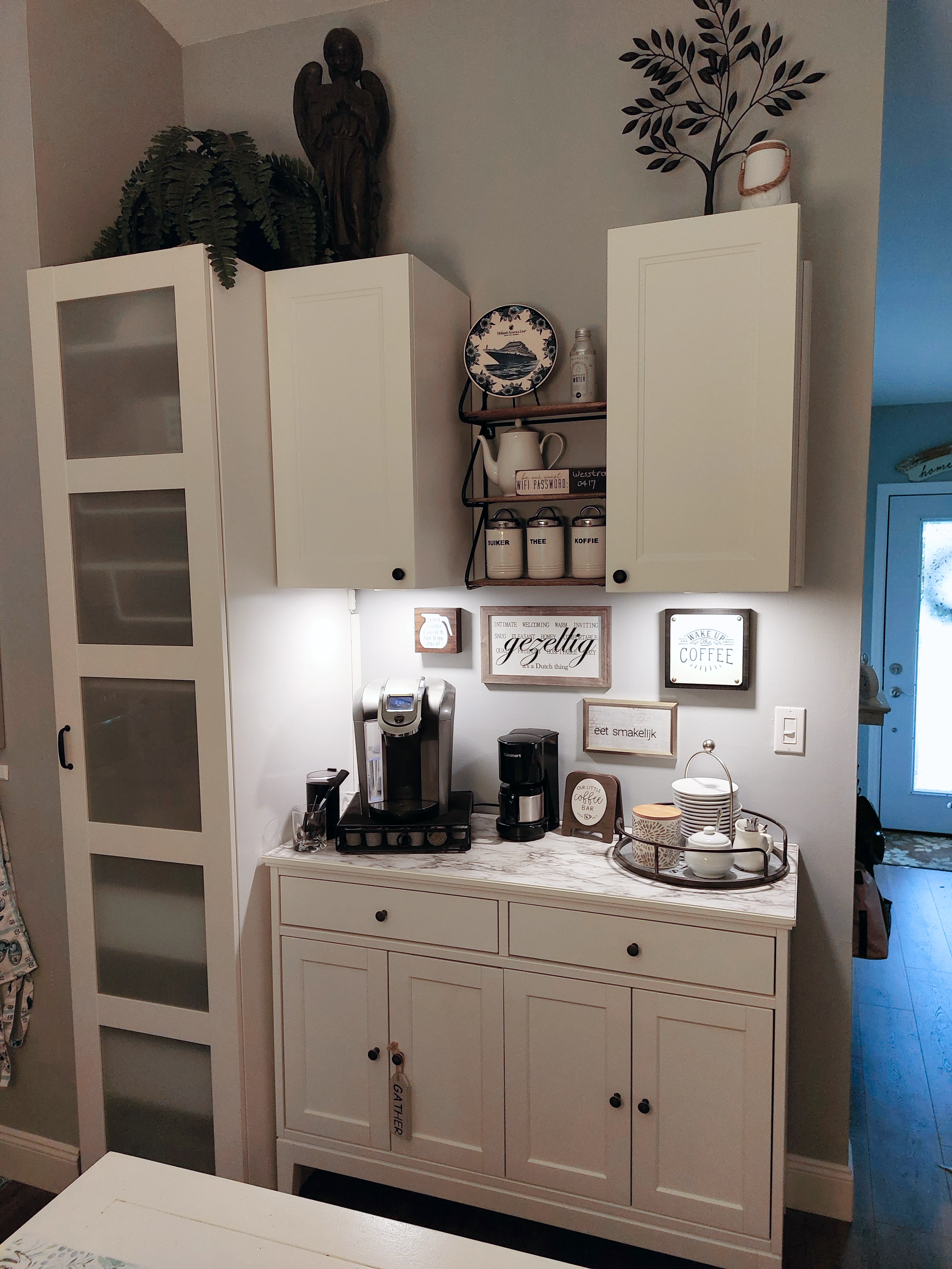 Coffee bar styled with shelves, art, and storage