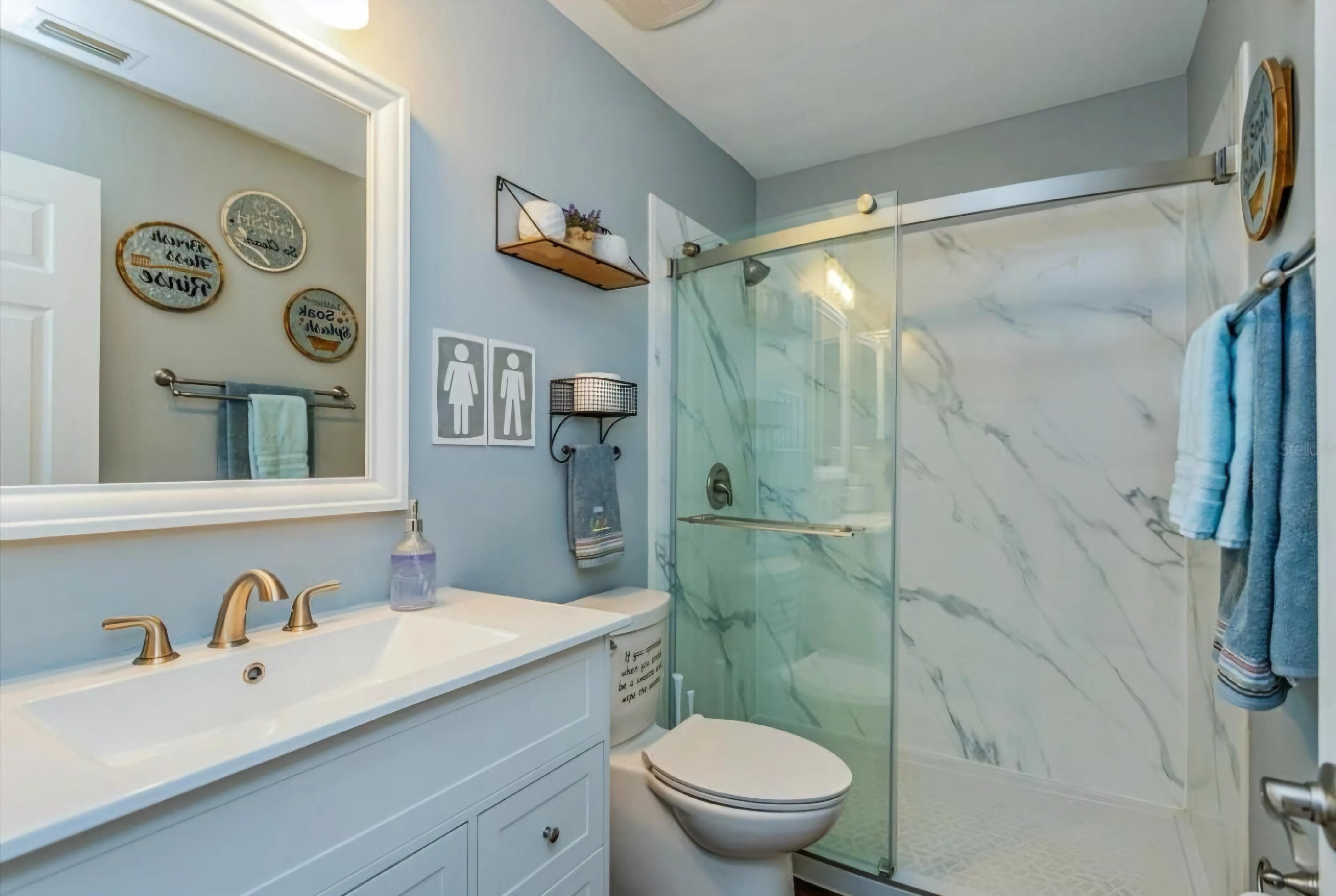 Guest bath refreshed with bright finishes and practical storage