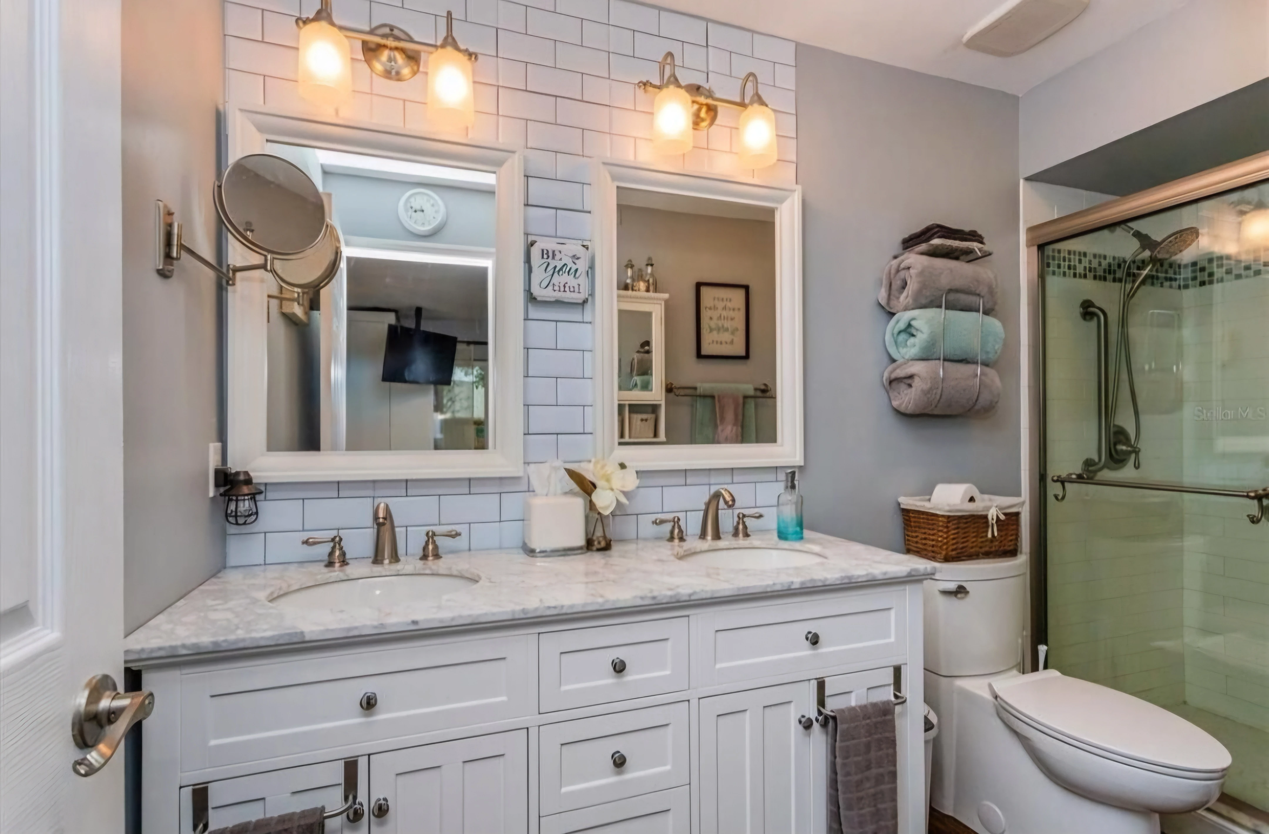 Updated bathroom with white vanity and warm lighting