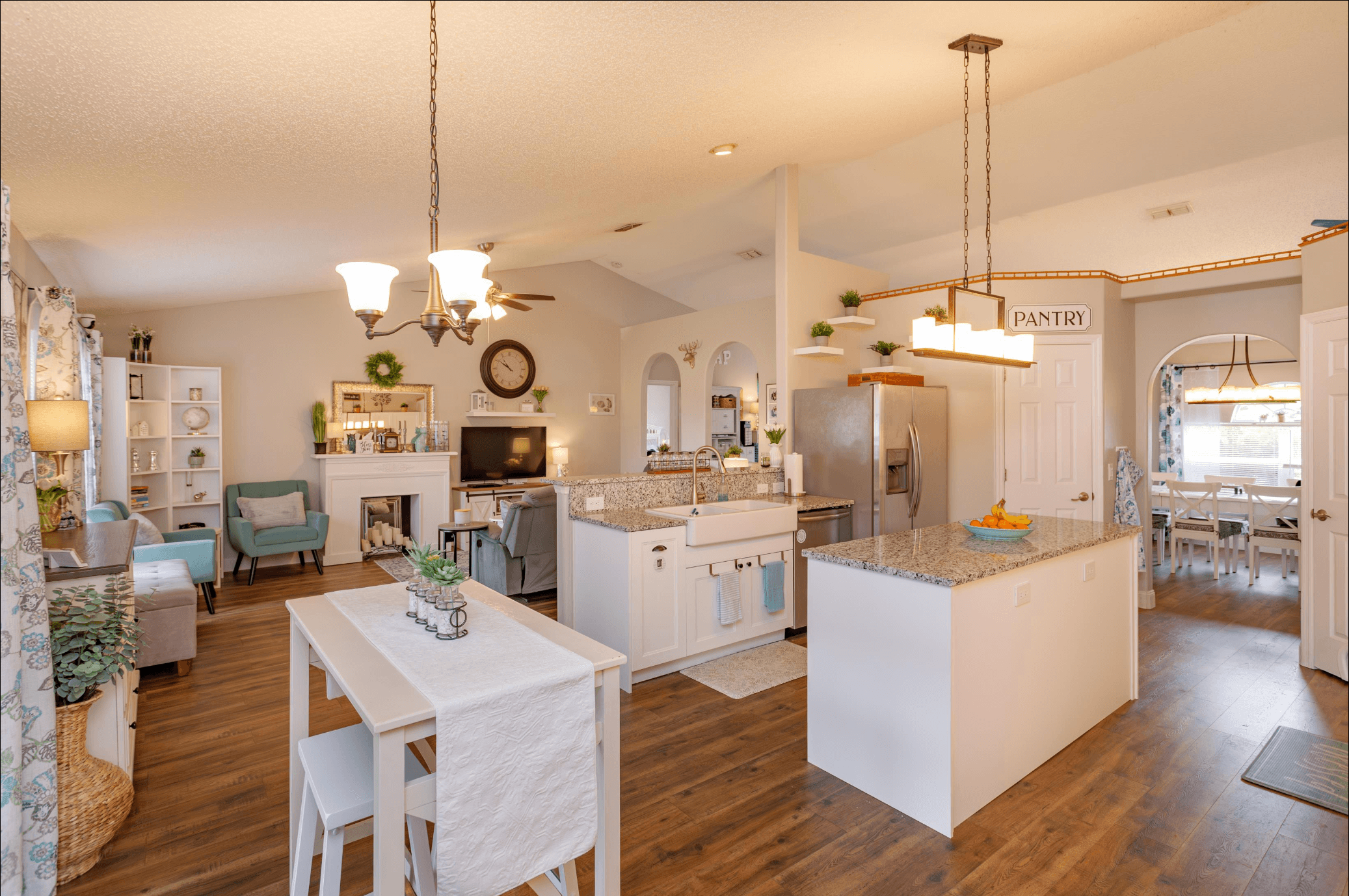 Bright open-plan home with styled living area, kitchen island, and dining room