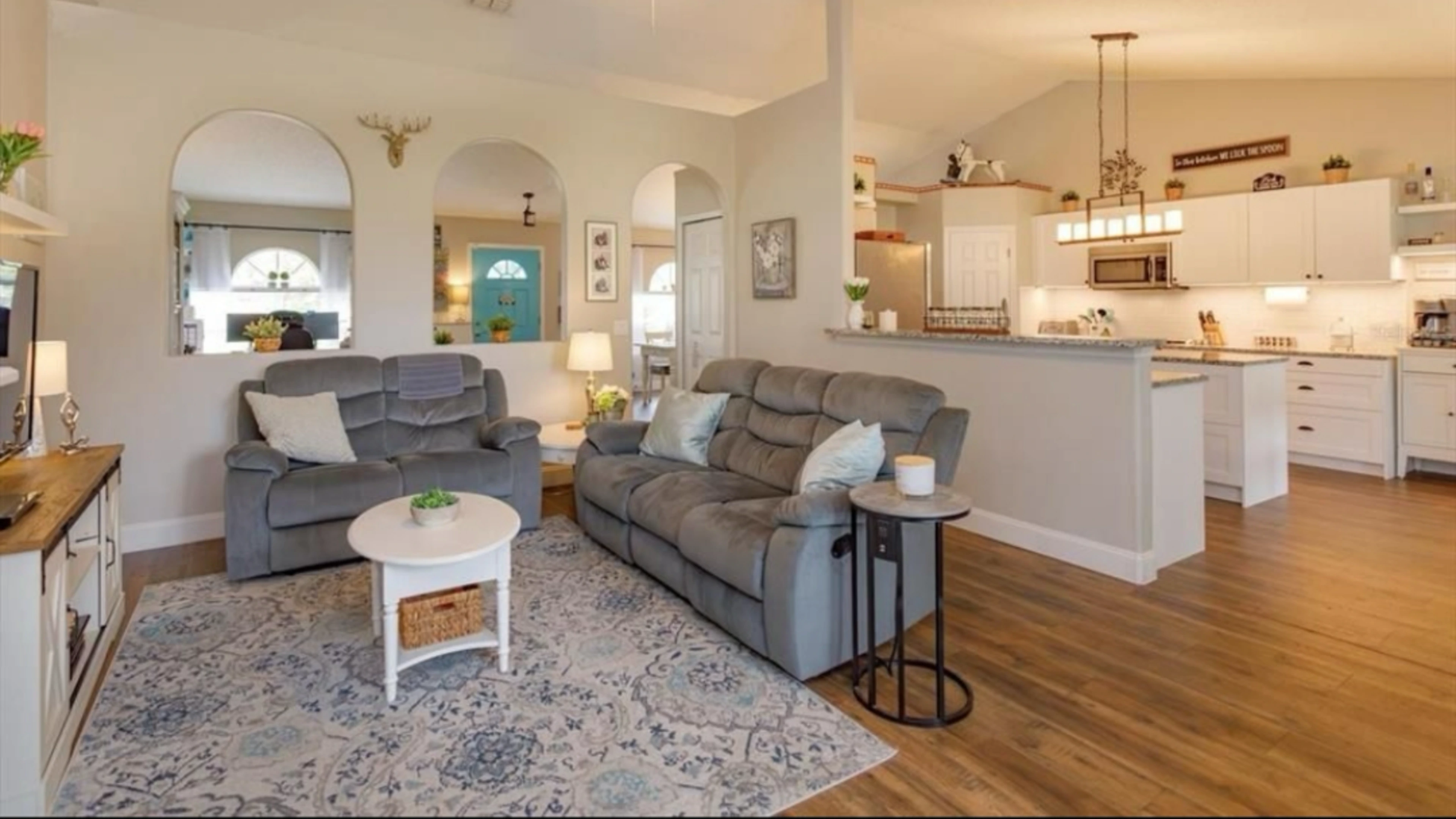 Styled living room with fireplace and light seating